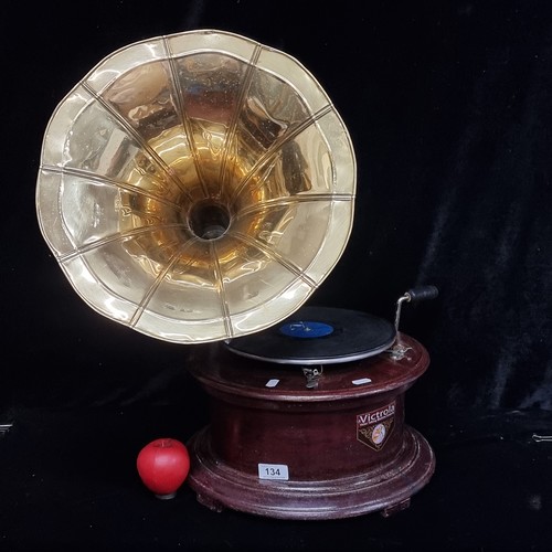 134 - A reproduction wooden cased table top wind up trumpet gramophone marked 