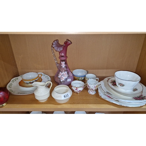 633 - Assorted china teacups, saucers, and plates with floral designs. Decorative pink glass pitcher. Two ... 