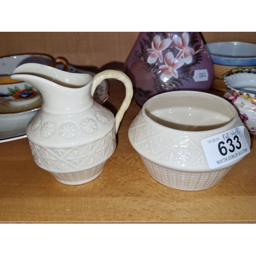 633 - Assorted china teacups, saucers, and plates with floral designs. Decorative pink glass pitcher. Two ... 