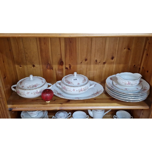 644 - Porcelain dinnerware set features floral motifs and gold trim, includes tureens, platters, and plate... 