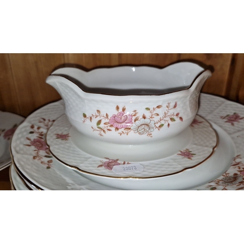 644 - Porcelain dinnerware set features floral motifs and gold trim, includes tureens, platters, and plate... 