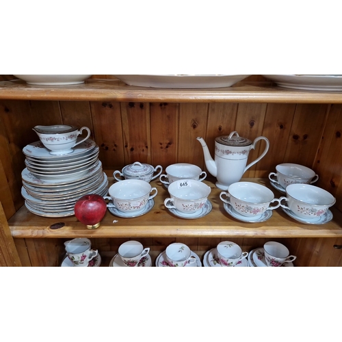 645 - Porcelain teaware set with floral pattern and gold trim, includes multiple plates, teacups with sauc... 