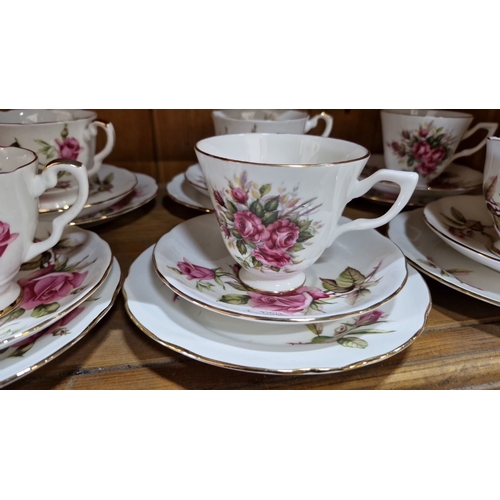 646 - Royal Stuart Roses tea set features rose floral designs with gold trim. Includes eight teacups, sauc... 