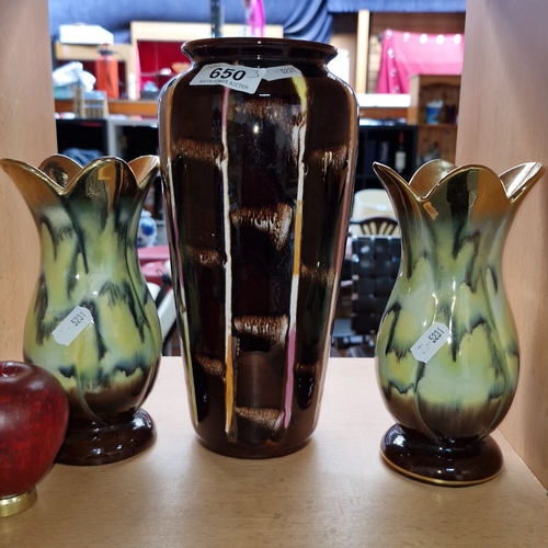 Set of three German pottery vases, including one tall vase with a rich brown glaze and two smaller vases featuring green and black motifs. Marked “Germany 536/18.”