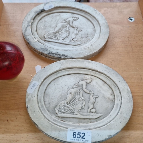 652 - Pair of antique oval plaster relief plaques depicting classical figures. Both pieces marked 