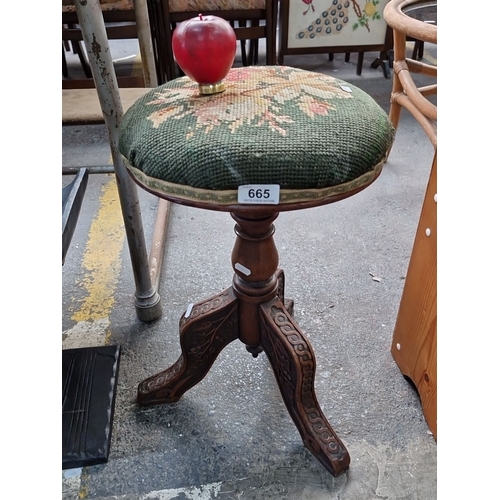 665 - Victorian walnut  stool with intricately carved legs and floral needlepoint upholstery from the late... 