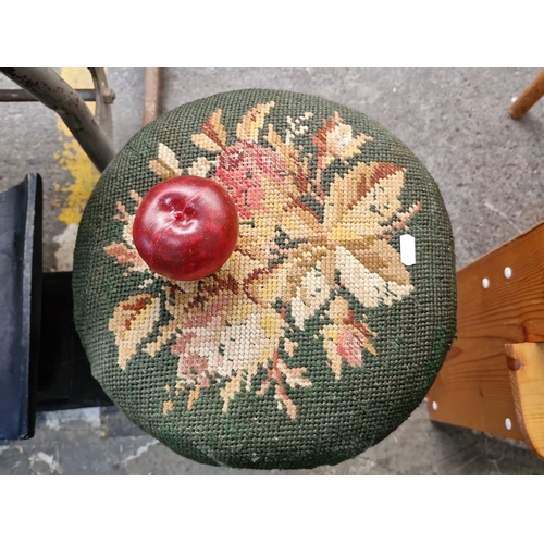 665 - Victorian walnut  stool with intricately carved legs and floral needlepoint upholstery from the late... 