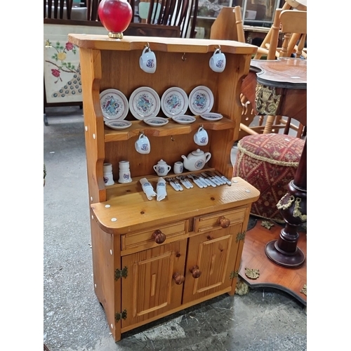 666 - A miniature Vintage wooden dollhouse furniture hutch with miniature tea set, including plates, cups,... 