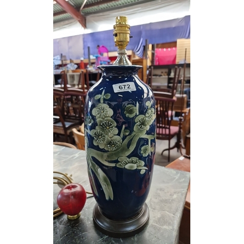 672 - A lovely large  ceramic table lamp with floral design on cobalt blue glaze, featuring brass fittings... 