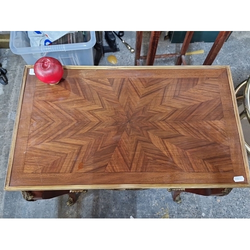 694 - Star Lot : A very handsome French Louis XV-style wooden table with brass inlay and ornate detailing.... 