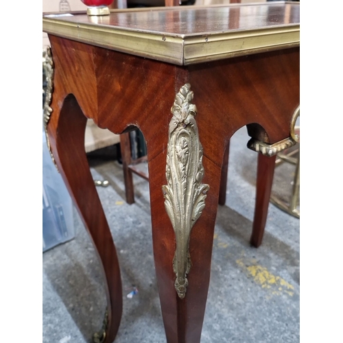 694 - Star Lot : A very handsome French Louis XV-style wooden table with brass inlay and ornate detailing.... 