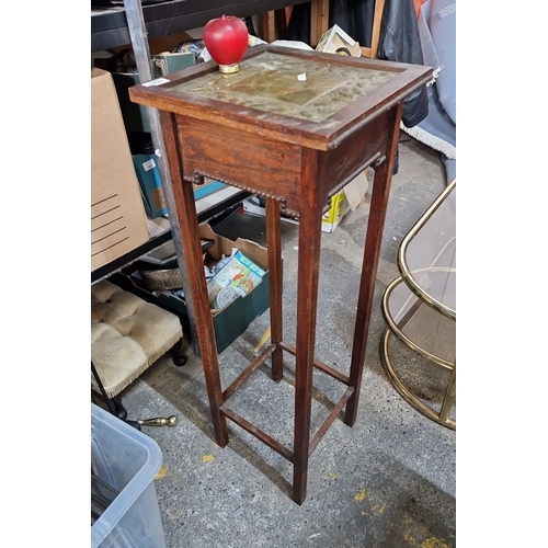 695 - An antique Oak plant stand with brass leaf motif inlay, from the early 20th century.