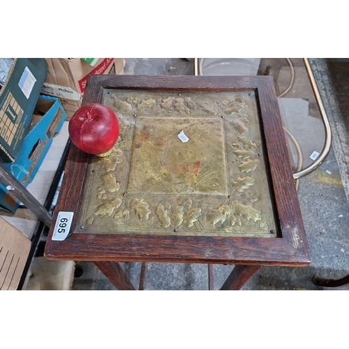 695 - An antique Oak plant stand with brass leaf motif inlay, from the early 20th century.