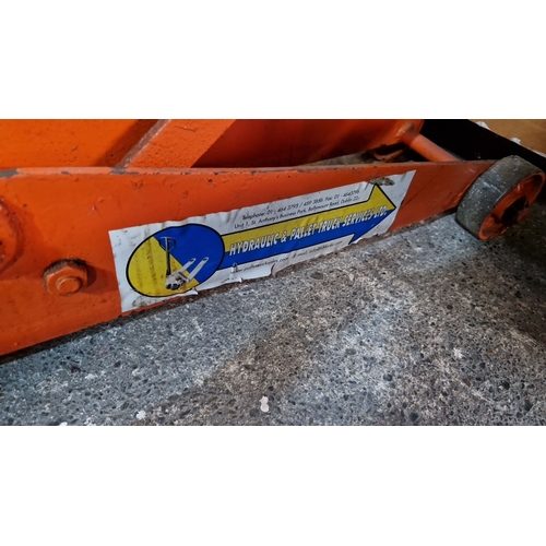 697 - A heavy Duty Hydraulic pallet truck by Hydraulic & Pallet Truck Services Ltd., Dublin. Bright orange... 