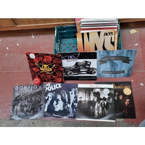 285 - A crate of approx 40 vinyl record albums from artist such as Aerosmith x2 , Bon Jovi x2 , The black ... 