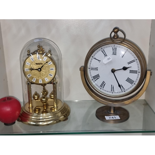 741 - Two vintage clocks, one heavy brass example and a domed anniversary example with a rotating pendulum... 