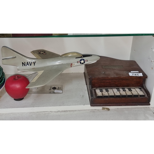 745 - Two items including a Vintage mini piano made of oak and an F9F-8 Cougar Grumman Navy jet model on a... 