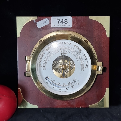 748 - A rather handsome heavy solid brass Stockburger ships barometer, mounted on a wooden base.