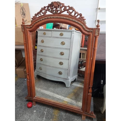 717 - Star Lot : A vintage large carved wooden mirror featuring floral scroll motifs to top and two turned... 