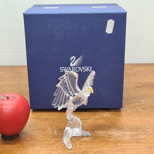 784 - A majestic Swarovski Crystal Bald Eagle. In original presentation box with certificate of authentici... 