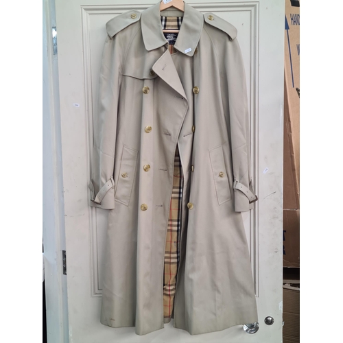 790 - Star lot : A Burberry's of London designer men's trench coat with belt and classic check lining. Ver... 