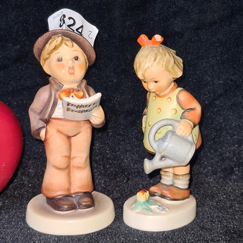 824 - Two charming West German Goebel Hummel figurines. Both in good condition stamped to base.