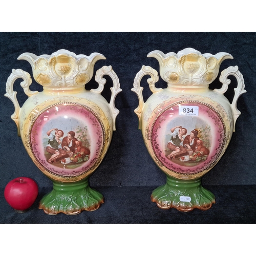 834 - A pair of very pretty Victorian twin handled vases decorated in multi lustre colours.