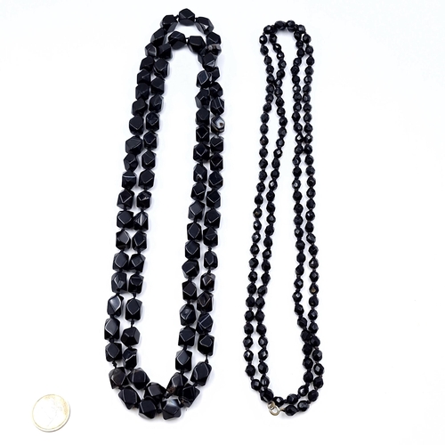 523 - Two jet necklaces. Length - 60 cms. Total weight of items - 254 grams.