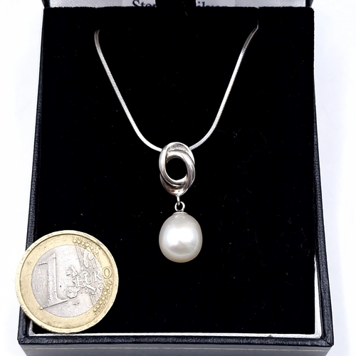 524 - A sterling silver modernist drop pendant necklace set with pearl accent. Length of chain - 54 cms. W... 