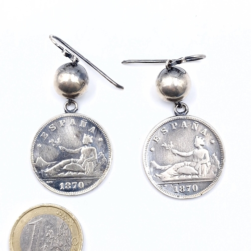 526 - A pair of Silver Spanish Pesetas dated 1870 - suitable for pierced ears. Weight - 14.1 grams.