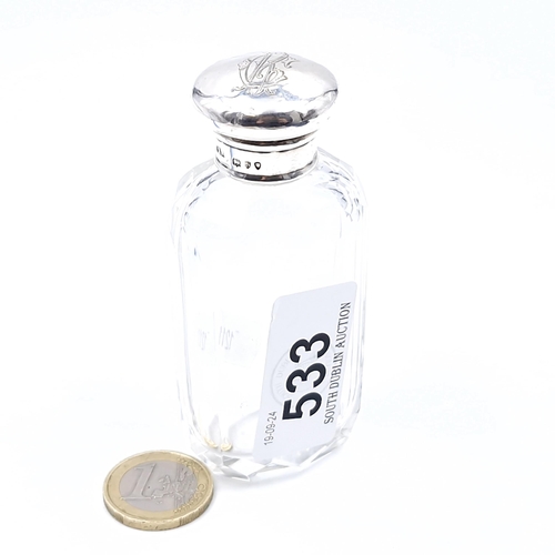 533 - A sterling silver glass fluted dressing table bottle. Top marked 'London'. Top with initialled monog... 