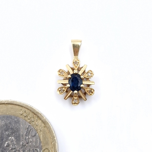 538 - Star Lot : A nine carat gold star design sapphire and diamond stone pendant. Weight 0.94 grams.