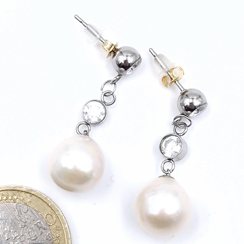 544 - Super Star lot : A pair of 18 carat gold Akoya pearl and diamond earrings. Est. weight of diamond is... 