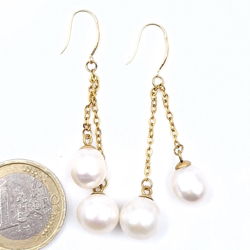 545 - Star Lot : A pair of 18 carat yellow gold Akoya pearl earrings.