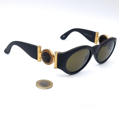 554 - A fine pair of Gianni Versace Sunglasses in super condition. Frames marked 'Made in Italy'. Model no... 