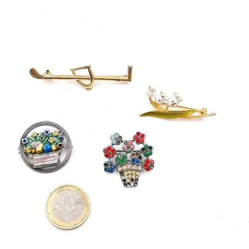 556 - A collection of four vintage brooches. An equestrian example and an enamelled Lily of the valley bro... 