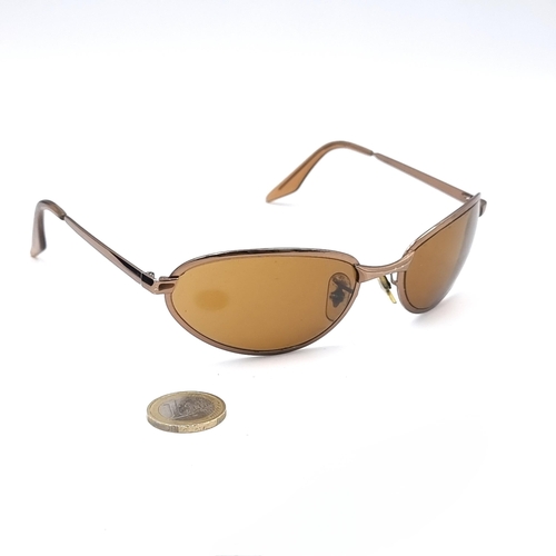 558 - A pair of as new Ray-Ban sunglasses with gold metal frames. Lenses clear. Comes in Ray-Ban pouch.