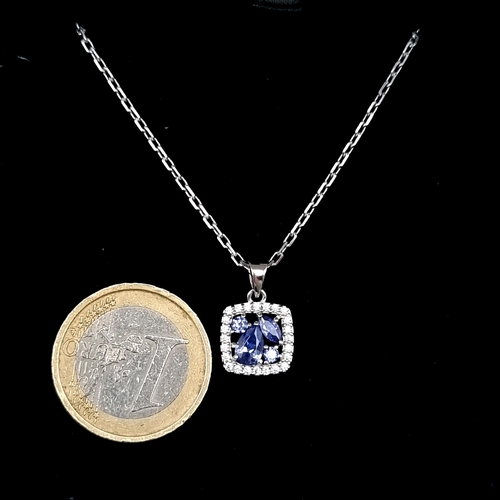 563 - A super Tanzanite pendant with white sapphire mount set in sterling silver with silver chain. Length... 