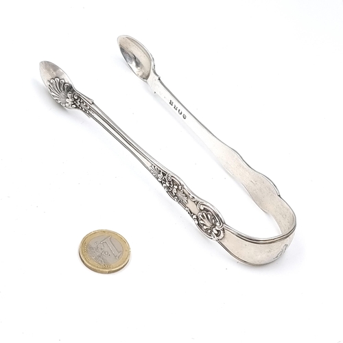 566 - A very fine pair of Irish Georgian silver sugar tongs set with shell and foliette decoration. Hallma... 