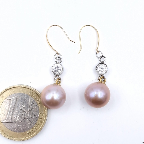 568 - Star Lot : A pair of 18 carat gold Akoya pearl diamond earrings. Est. weight of diamonds - 0.60 cara... 