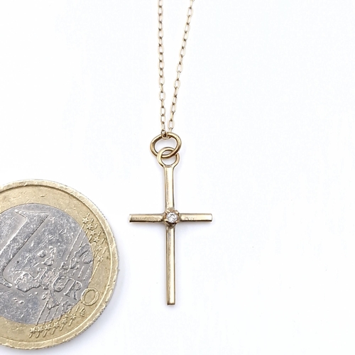 571 - A nine carat gold cross & chain. Length - 40 cms. Weight - 1.15 grams.