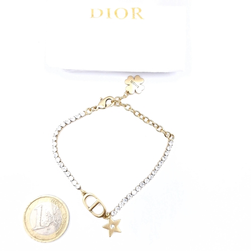 594 - A brand new designer Dior gem set bracelet with Christian Dior charm. Weight - 6.26 grams.