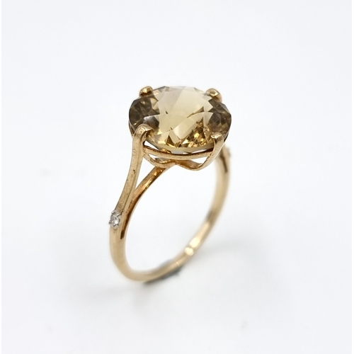 600 - Star Lot : A pretty smokey quartz gemstone ring with diamonds to band set in nine carat gold (375). ... 