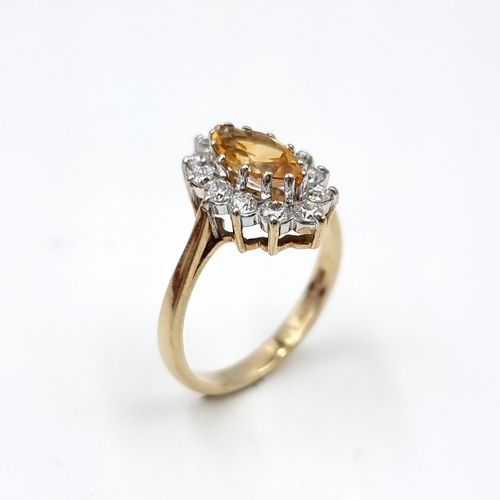 603 - Star Lot : A nice example of a citrine gemstone ring set with  diamond surround mounted in nine cara... 