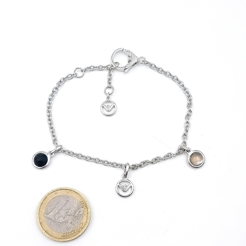 616 - A designer Emporium Armani sterling silver bracelet, with four Armani charms. Set with a chain link ... 