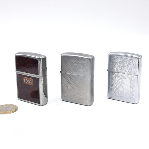 625 - Three excellent examples of genuine Zippo lighters including a planeta leather wrap dating to 1951, ... 