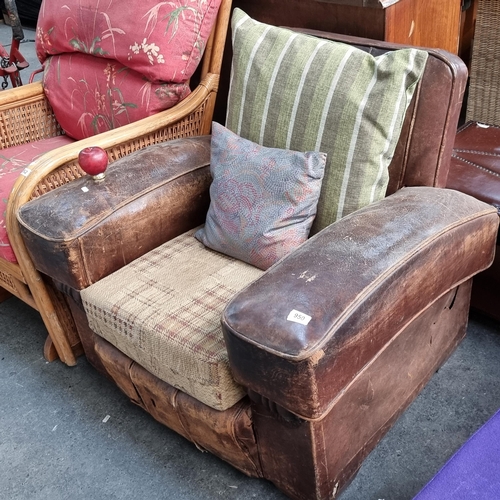 950 - A marvelous vintage leather armchair. A real statement piece in need of reviving but with plenty of ... 