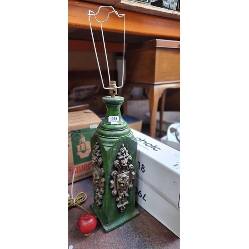 968 - A very large green wooden table lamp with lion mask decoration and  bayonetted bulb fixture.