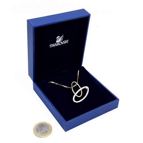 999 - A brand new very pretty gold toned Swarovski necklace with entwined circle pendant. Model No. 869850... 