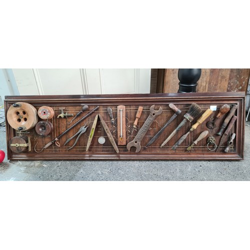 314 - An antique display board with old fishing gear, levels, and old tools. A fabulous display piece for ... 